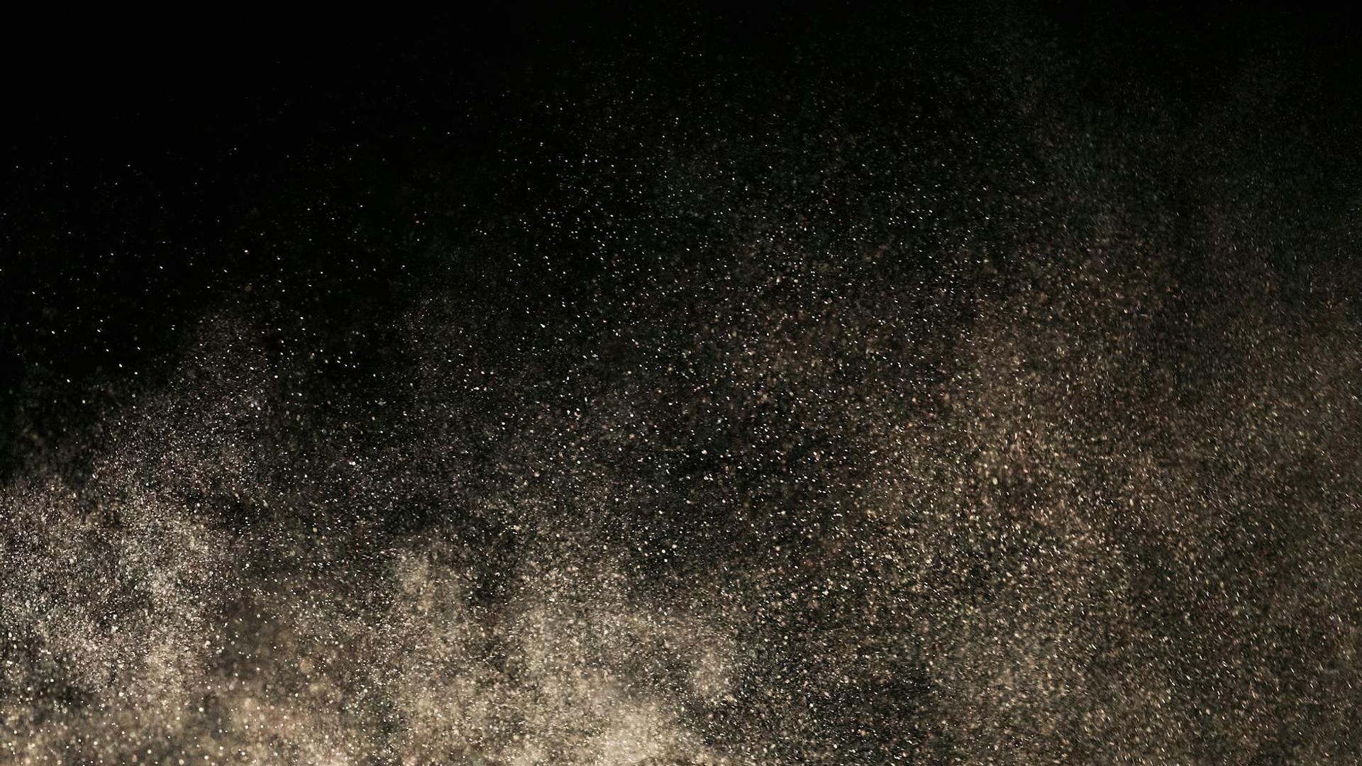 Abstract dark background with subtle texture suggesting focus and depth.