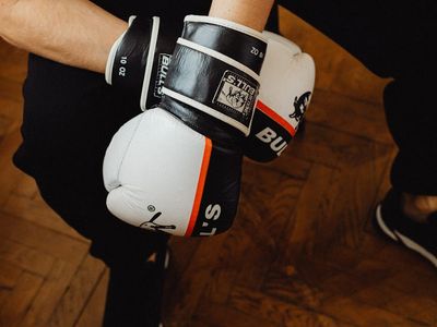 Close-up on a person's hands during a floor exercise, showing concentration.